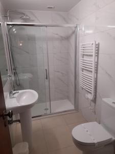 a bathroom with a shower and a toilet and a sink at 413 Casa Marsalema in Salema