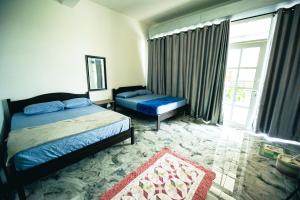 Ένα ή περισσότερα κρεβάτια σε δωμάτιο στο MKB Homestay - Landed Studio room with 2 Queen bed and Free Parking