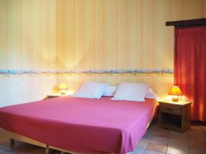 a bedroom with a large pink bed with two lamps at Sunny Provence Home with Terrace in Monteux