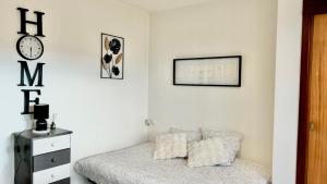 a bedroom with a bed and a clock on the wall at Studio cosy Vue imprenable Aix Les Bains in Aix-les-Bains