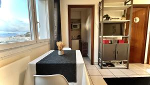 a dining room with a table and a window at Studio cosy Vue imprenable Aix Les Bains in Aix-les-Bains