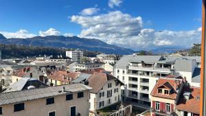 a view of a city with buildings and mountains at Studio cosy Vue imprenable Aix Les Bains in Aix-les-Bains