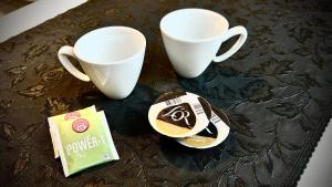 a table with two cups and a packet of coffee at Studio cosy Vue imprenable Aix Les Bains in Aix-les-Bains +18 photos