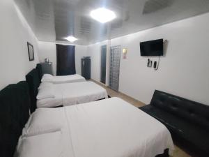 Voodi või voodid majutusasutuse Hotel Palmari toas