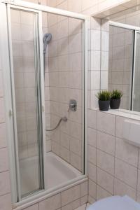 a shower with a glass door in a bathroom at Windhauch in Westermarkelsdorf