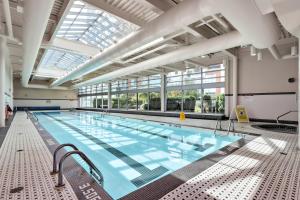a large indoor swimming pool with a large ceiling at Stylish Condo in Downtown in Vancouver