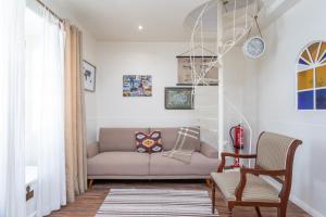 a living room with a couch and a staircase at BeGuest Tia Benvinda Cascais in Cascais