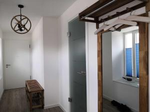 Zimmer mit einer Tür, einem Stuhl und einem Kronleuchter in der Unterkunft FeWo Prora - MeerSonneWind in Binz