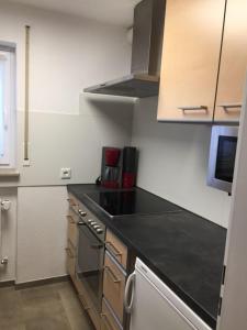 a kitchen with a black counter top and a stove at EG Villingendorf in Villingendorf +2 photos