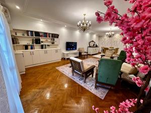 a living room with a couch and a table and chairs at Vintage Charm & Spacious Comfort in Zayed 2000 - only families & single travelers in Sheikh Zayed