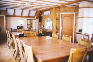 a dining room with wooden tables and chairs at Haus Irsa in Over de Dijk