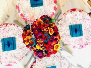 a bouquet of colorful flowers on white lace plates at A Breathtaking LUX Home in Puerto Vallarta +104 photos