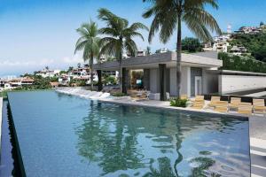 a swimming pool with palm trees and a house at A Breathtaking LUX Home in Puerto Vallarta