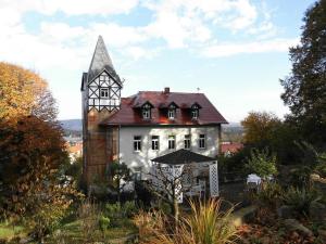 a large white house with a tower on top of it at 2 Norit Schlosser Comfortable holiday residence in Heidenau