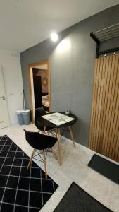 a room with a table and a chair in a room at Ferienwohnung Schloßberg 2 in Peiting +16 photos