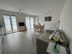 a living room with a couch and a table at View Point Lake and Mountains in Annecy