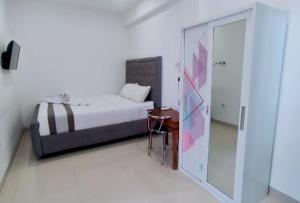 Postel nebo postele na pokoji v ubytování Carstenzs Home Kuta