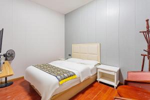 Uma cama ou camas num quarto em Kunming Panju Hotel Changshui Airport Branch