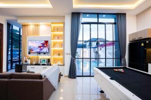 a living room with a pool table at Ada poolvilla pattaya in Ban Huai Yai
