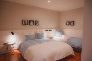 a bedroom with two beds with white sheets at Sahel in Westermarkelsdorf