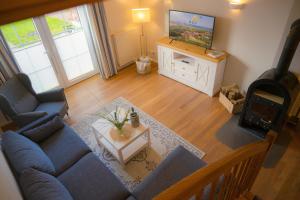 a living room with a blue couch and a tv at Vento in Westermarkelsdorf