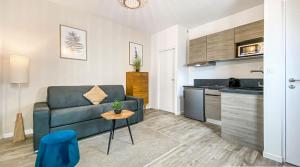 a living room with a couch and a table at HOMEY TITI - Hyper-centre - Proche Gare et Tram - Lit Convertible - Wifi gratuit in Annemasse +7 photos