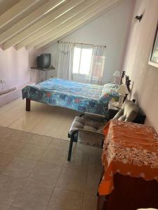 a bedroom with two beds and a window at Departamento 4 Ambientes frente al mar - San Bernardo - Cochera - Parrilla in San Bernardo