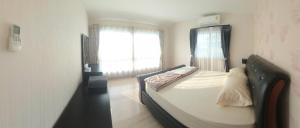 a bedroom with a bed and a window at A,B house Chiangmai in Chiang Mai