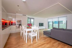 a living room with a table and a couch at Square Green - No 12 Garden in St. Andrews
