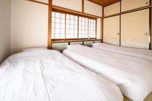 Katil atau katil-katil dalam bilik di 玉造和暖 WaDan 島根県玉造温泉街に佇む和の趣あふれる古民家旅館 supported by COCOSTAY