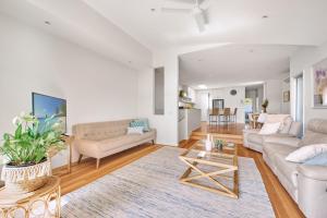 a living room with a couch and a table at Jan Juc Beach Home in Torquay