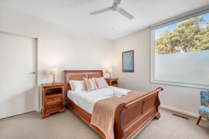 a bedroom with a bed and a large window at Jan Juc Beach Home in Torquay