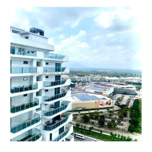 a tall white building with a city in the background at MRC Homes Azure North Pampanga in San Fernando +7 photos