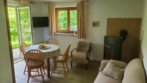 a living room with a table and chairs and a couch at Gut Hanerau, Eschenufer keine Monteure in Hanerau-Hademarschen