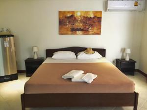 a bedroom with a bed with two towels on it at Blue Sky Residence in Patong Beach
