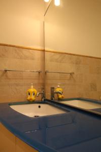 a bathroom with a sink with two eyes on it at Casa LORY in Varazze