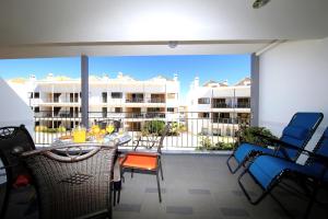 a patio with a table and chairs on a balcony at Apartment Karin, Town Centre in Tavira