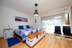 a bedroom with a bed and a desk and a window at Apartment Karin, Town Centre in Tavira +31 photos