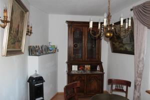 a room with a large wooden cabinet in the corner at Ferienwohnung für bis zu 8 Personen in Sehmatal