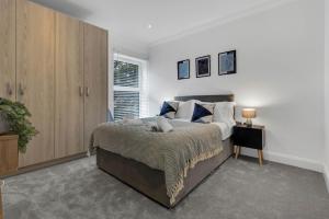 a bedroom with a large bed and a window at Cosy Modern Stay at St Mary's Nest Apartment By Your Lettings Short Lets & Serviced Accommodation Peterborough With Free WiFi and Parking in Huntingdon