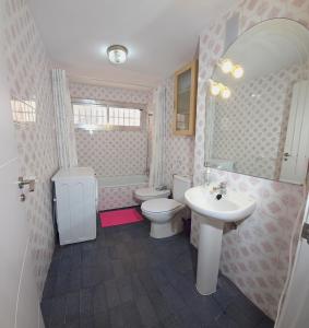 a bathroom with a sink and a toilet and a mirror at Vacansis Apartamento Cullera Mar in Cullera +33 photos