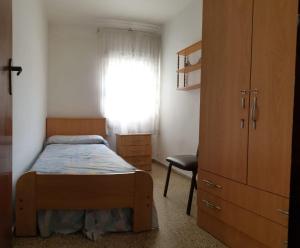 Un pat sau paturi într-o cameră la Vacansis Apartamento Pez Espada