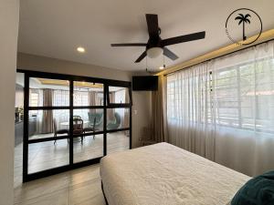 a bedroom with a bed and a ceiling fan at Loft en centro histórico de Mazatlán! in Mazatlán