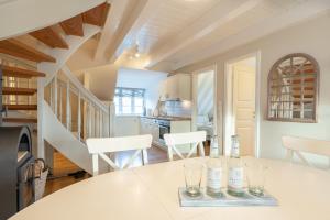 a kitchen with a table with wine glasses on it at Landhaus am Meer - Whg 7 Osterley in Utersum