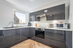 a kitchen with stainless steel appliances and a window at Spire View Apartment in St. Andrews