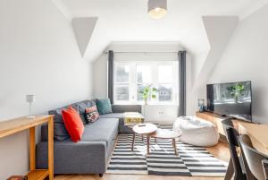 a living room with a couch and a table at Spire View Apartment in St. Andrews