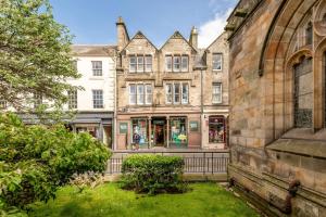 an old building with a store in front of it at Spire View Apartment in St. Andrews