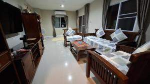 a living room with a couch and a table at A,B house Chiangmai in Chiang Mai