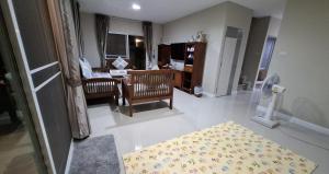 a living room with a table and a chair and a desk at A,B house Chiangmai in Chiang Mai +11 photos
