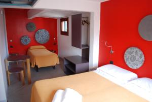 Postel nebo postele na pokoji v ubytování Hotel San Geremia